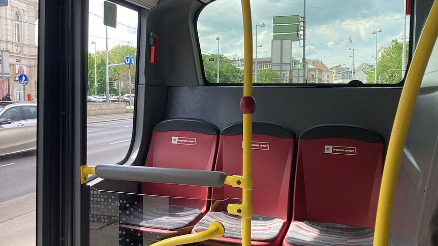 Leere rote Sitzplätze in der letzten Reihe eines Winer linien Buses